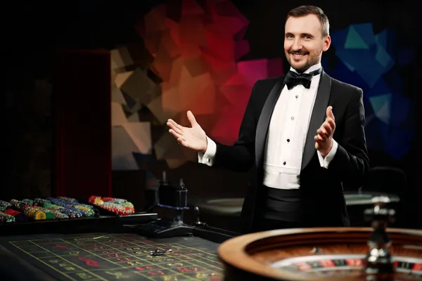 A glowing roulette wheel with cascading chips, symbolizing the engaging live and instant-win games available on 5XGAME.